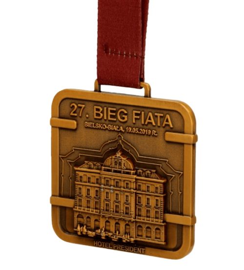 Medal odlewany bieg fiata w kolorze antyczne złoto na czerwonej wstążce