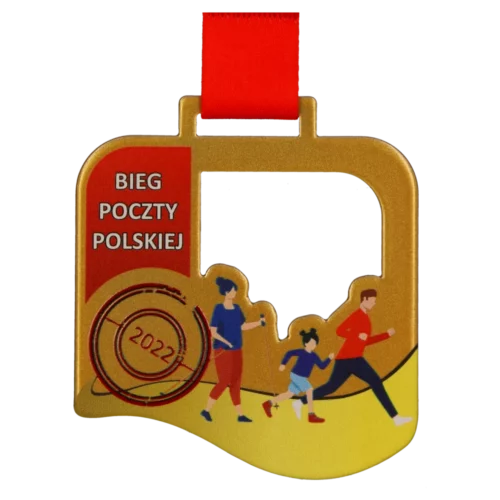 Złoty medal z nadrukiem biegaczy na czerwonej wstążce.